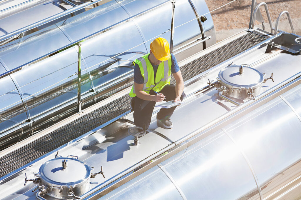 a worker inspecting a milk tanker to award BRCGS certification for food safety during transport