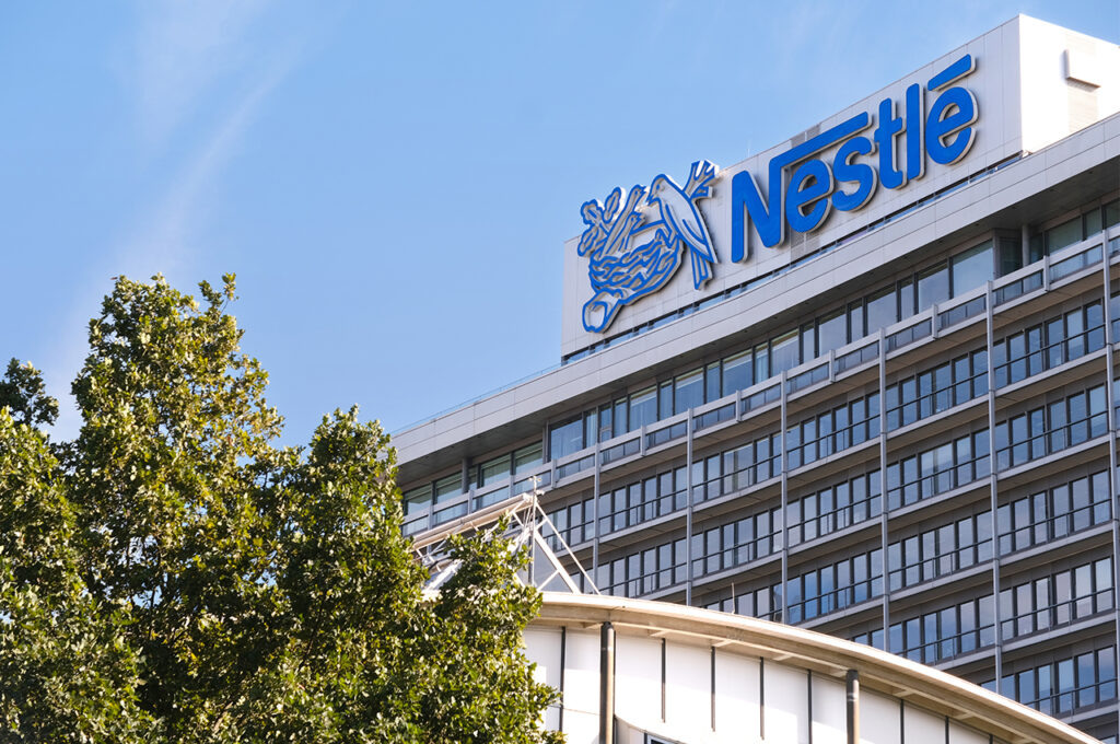 the Nestle headquarters framed by trees and against blue skies